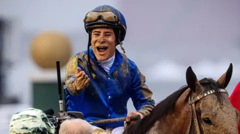 Junior Alvarado celebrates his Kentucky Derby win