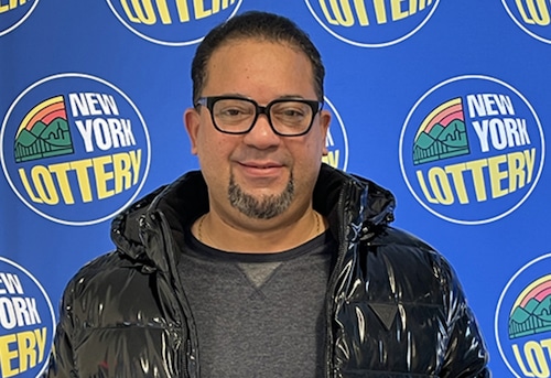 Excited winner holding a victorious ticket, nylottery excitement