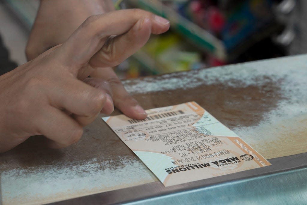 Players checking New York Lottery results on their tickets